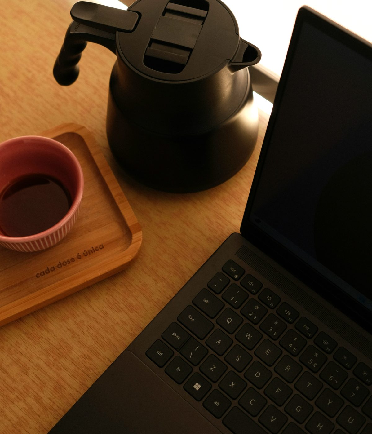 The editing desk: coffee, kettle, and a laptop mid-edit